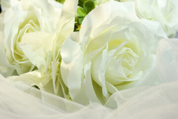 Fake white rose bouquet, tulle on table, rose fabric texture, artificial rose bouquet, romatic, valentine, wedding flower.