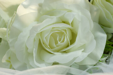 Fake white rose bouquet, tulle on table, rose fabric texture, artificial rose bouquet, romatic, valentine, wedding flower.