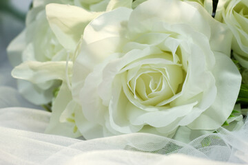 Fake white rose bouquet, tulle on table, rose fabric texture, artificial rose bouquet, romatic, valentine, wedding flower.