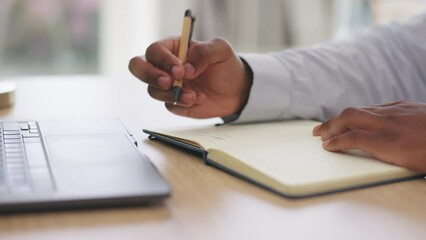 Notebook, hands and man writing summary of laptop finance info, stock market strategy or investment. Business economy, journal planner and African trader planning bitcoin, forex or trading plan