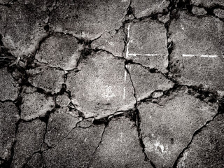 In the eerie black and white landscape, the concrete is riddled with many cracks. Double exposure...