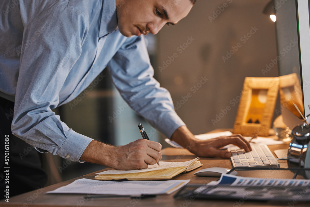 Poster Business man, writing and data with keyboard, analytics and IT code, work overtime for deadline and notebook. Working night, email and programming, checklist with digital notes and software update