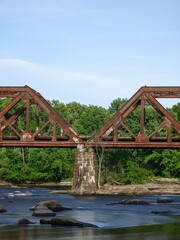 steel bridge over a river in the region of new england in the united states of america