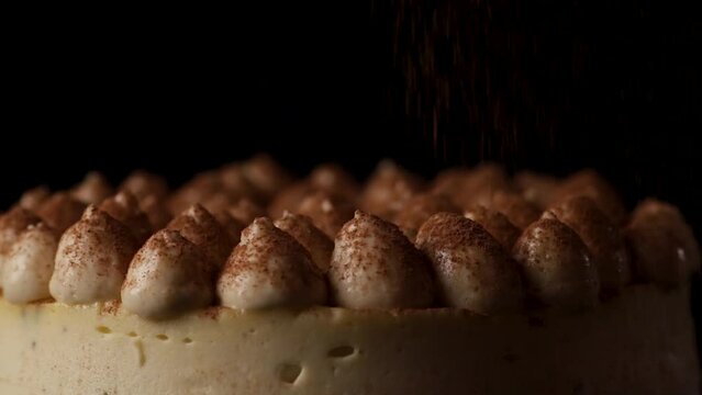 decorated cheesecake with cocoa and pine nuts rotated. closeup video food.
