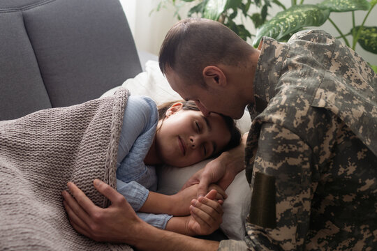 Soldier surprises the sleeping family with his arrival at home.