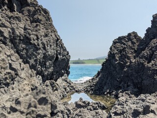 rocks and sea, with the coast in the background, natural landscape in veracruz, mexico, sea, latinoamerican paradise