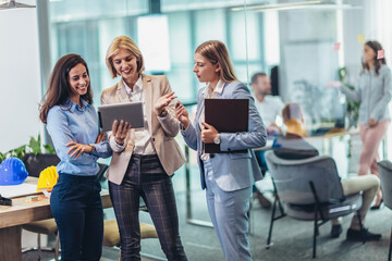 Three businesswomen talking in the office.