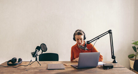 Female radio dj preparing a show in a studio