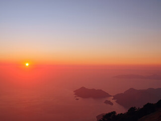 Summer scenery of Blue Lagoon with white sand located in city Oludeniz. Beautiful view on summer sea and town from top moutain. Sunset time