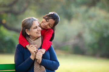 Indian little girl with her grandmother at park.