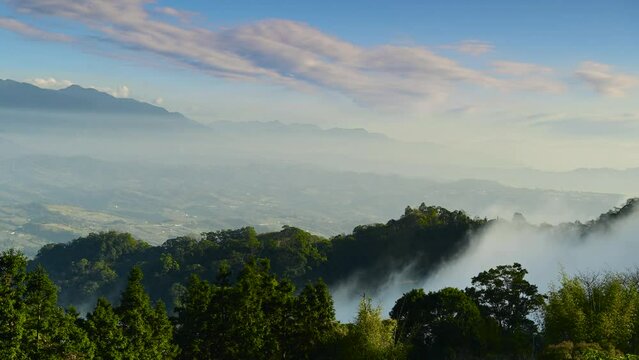 The valleys and mountains are shrouded in mist. Lush hilltops. Looking far away from the top of the mountain. Dahu Township, Miaoli County, Taiwan