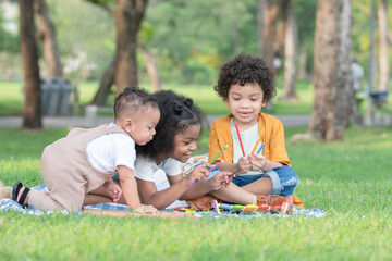 Naklejka na ściany i meble Little cute African children sitting and have fun playing xylophone making music sound while picnic at park together. Sibling relationship in family. Lifestyle and education concept