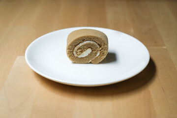 Coffee roll cake on white plate, Selective Focus.