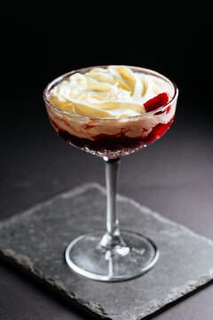 glass of alcoholic coctail with ice on black background