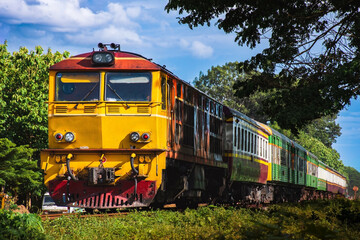 Obraz premium Passenger train by diesel locomotive on the railway.