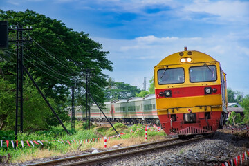 Passenger train by diesel locomotive passes the railway curve. 