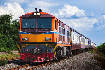 Obraz premium Passenger train by diesel locomotive on the railway.