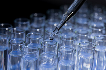 Pipette dropping fluid into test tube