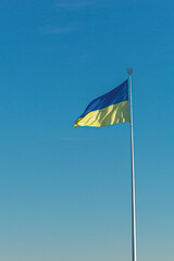 Ukrainian flag against the blue sky