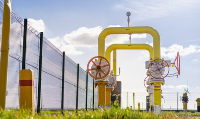 Gas valves in a distribution center - yellow thick steel pipes
