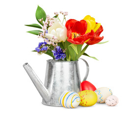 bouquet of flowers in a decorative watering can and easter eggs on a white isolated background
