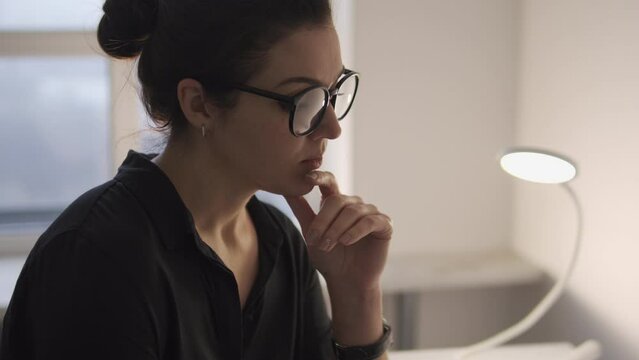 Beautiful young woman playing with hair on her neck and smiling, flirting online