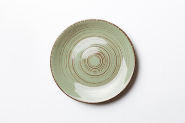 Top view of isolated of colored background empty round green plate for food. Empty dish with space for your design