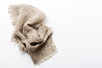 Old burlap fabric napkin, sackcloth on table background. top view with copy space