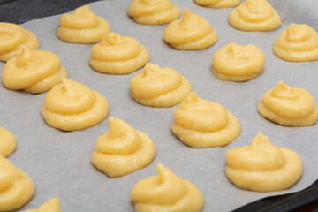 French Cheese Puffs. Gougeres French pastries on a dripping pan before baking