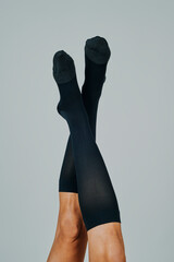 upside down man wearing compression socks - 570202235