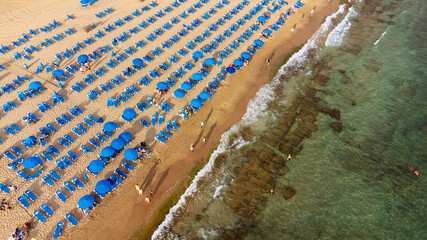 summer and travel concept - beautiful aerial view of summer beach with tourists, sunbeds and...