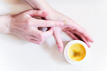 Natural organic salve (balm, cream) in hands with wooden spoon