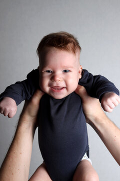 Father holding his smiling son in his arms