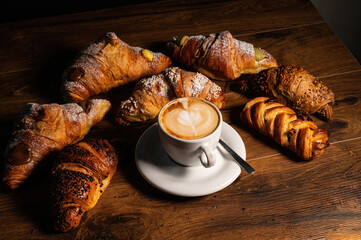 sweet croissants with cream and cappuccino