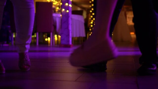 Dancing feet at a party with blurry lights