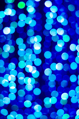 Beautiful blue night bokeh light, abstract blur defocused background. Colorful overlay glitter lights for layout design. Boke glows concept of Celebration, Christmas or festival seasonal background.