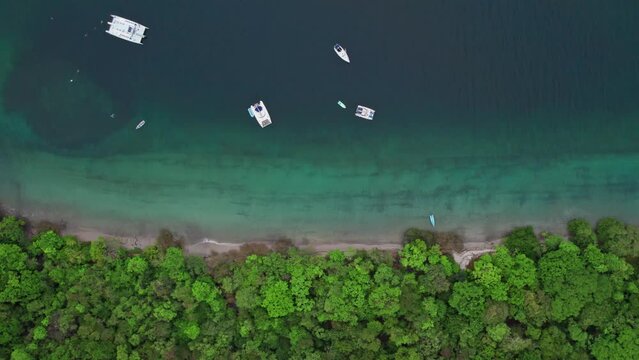 Boats anchored in the sea, in the beautiful Jicaro beach in Costa Rica.