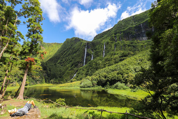 Hikers enjoy the silence with the view of the idyllic lagoon and waterfalls Po&ccedil;o da Alagoinha on the island of Flores in the Azores.
What a paradise!
Flores, Azores - in the Atlantic Ocean