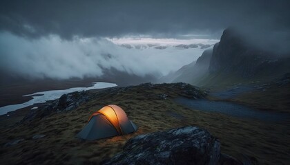 A glow from a tent perched on green rocky fields with the mist fast approaching the campsite. Generative ai composite.