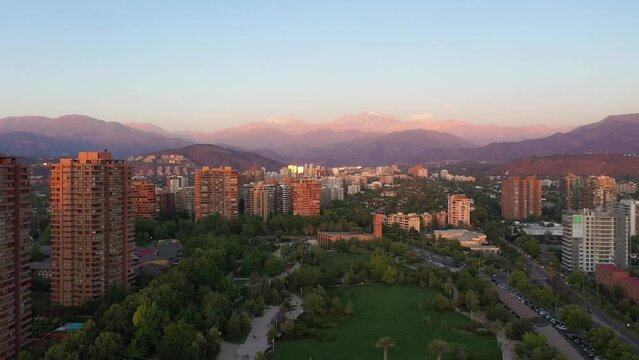 Las Condes Commune in Santiago and Andes Mountains at Sunset. Residential Buildings. Aerial View. Chile. Drone Flies Upwards