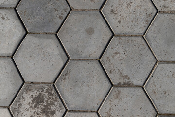 Sidewalk paved with concrete hexagons.