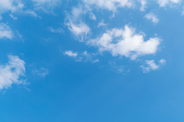 Background of winter blue sky with white clouds. Beauty clouds in sunshine floating in the sky high.