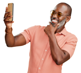 A happy trendy mature African American man taking selfies on his cellphone for his social media post isolated on a PNG background.