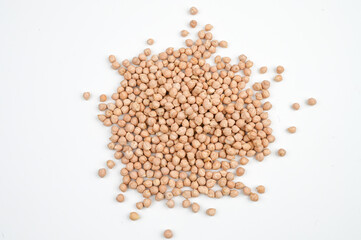 A pile of scattered dry chickpeas on white background top view