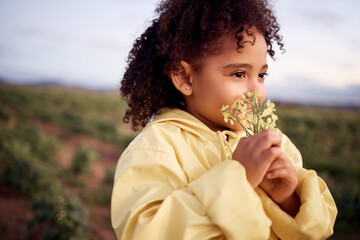 Children, farm and a girl smelling a flower outdoor in a field for agriculture or sustainability....