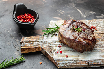grilled beef steak with spices on a wooden board, Restaurant menu, dieting, cookbook recipe top view