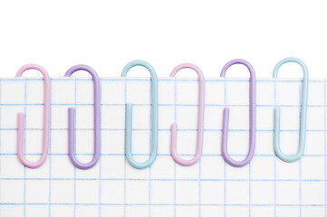 Office paper clips on a sheet of paper