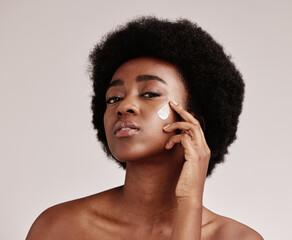 Beauty, portrait of black woman with cream on face and afro, advertising luxury skincare with...