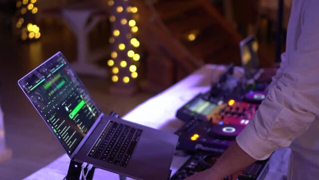 Unrecognizable DJ playing music at a wedding party
