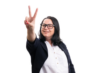 Smiling female model entrepreneur making peace or victory sign